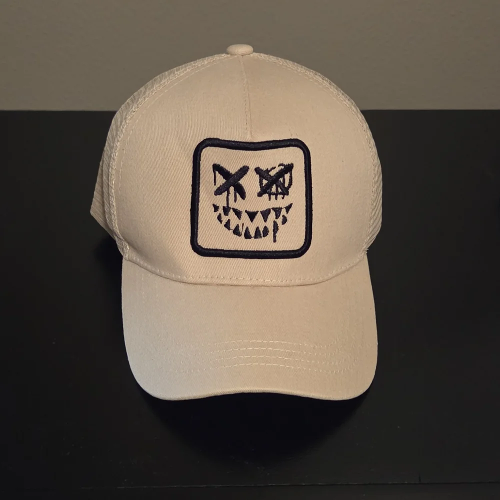 NWOT Beige Cap with Embroidered Face Design